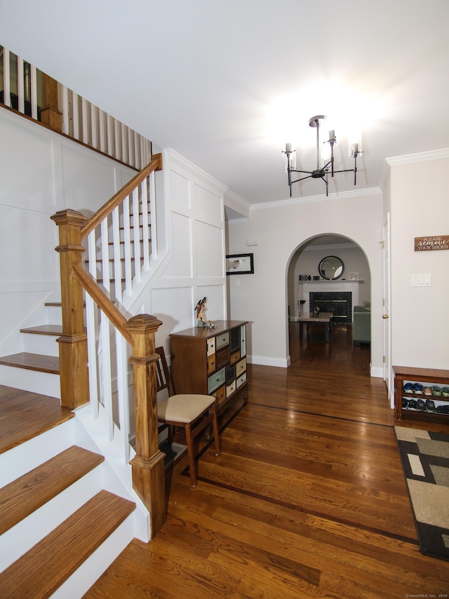 625 Lakeview Rd, Orange, CT 06477 - stairs with arched walkways, crown molding, a chandelier, and wood finished floors