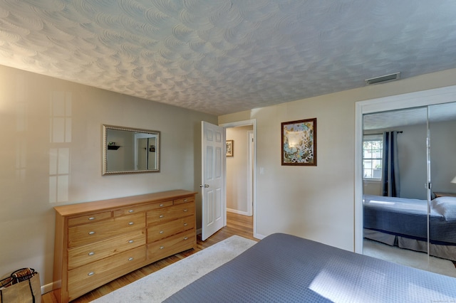 23 Sun St, Enfield, CT 06082 - bedroom featuring wood finished floors, a textured ceiling, and a closet