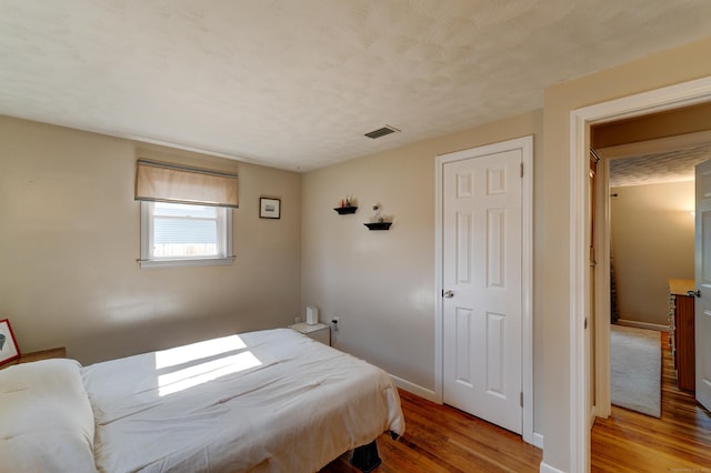 23 Sun St, Enfield, CT 06082 - bedroom with light wood-style floors and a textured ceiling