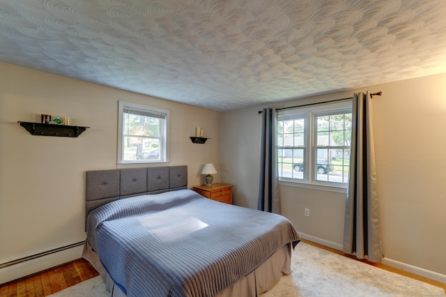 23 Sun St, Enfield, CT 06082 - bedroom featuring a baseboard radiator, multiple windows, and a textured ceiling
