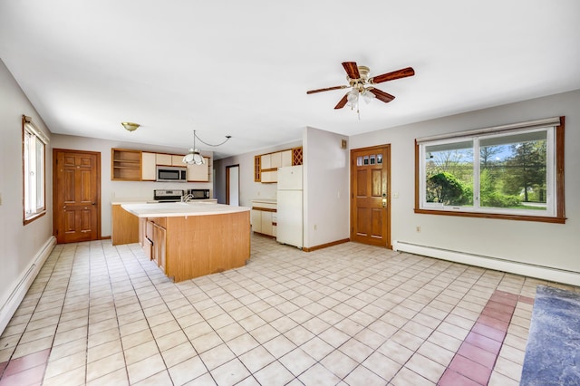 6 Victoria Dr, Colchester, CT 06415 - kitchen with stainless steel microwave, freestanding refrigerator, light countertops, baseboard heating, and a center island