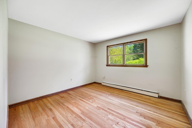 6 Victoria Dr, Colchester, CT 06415 - empty room with a baseboard heating unit and light wood-type flooring