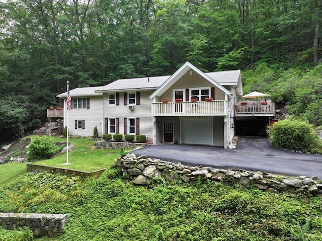 135 Green Pond Rd, Sherman, CT 06784 - view of front of property featuring asphalt driveway, an attached garage, a view of trees, and a deck
