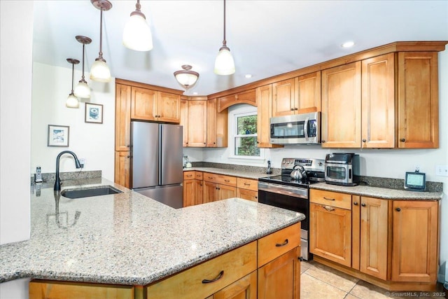 135 Green Pond Rd, Sherman, CT 06784 - kitchen with stainless steel appliances, a peninsula, light stone counters, hanging light fixtures, and recessed lighting