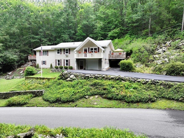 135 Green Pond Rd, Sherman, CT 06784 - view of front of property with a garage, a forest view, driveway, and a wooden deck