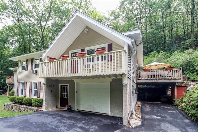 135 Green Pond Rd, Sherman, CT 06784 - view of front of home featuring an attached garage, asphalt driveway, a balcony, and cooling unit