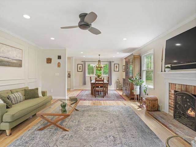 22 Rocky Ridge Dr, Trumbull, CT 06611 - living room featuring crown molding, light wood-style flooring, a fireplace, a ceiling fan, and recessed lighting