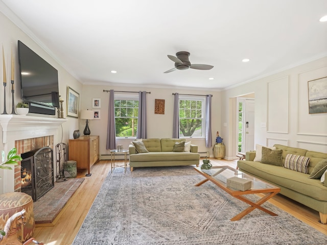 22 Rocky Ridge Dr, Trumbull, CT 06611 - living room featuring ornamental molding, ceiling fan, baseboard heating, a brick fireplace, and light wood-style flooring
