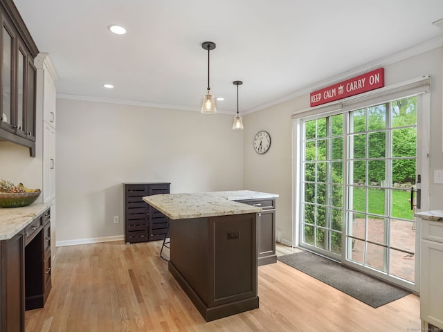 22 Rocky Ridge Dr, Trumbull, CT 06611 - kitchen featuring a center island, light wood-style floors, dark brown cabinets, crown molding, and hanging light fixtures