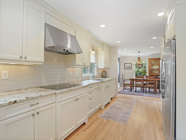 22 Rocky Ridge Dr, Trumbull, CT 06611 - kitchen with wall chimney exhaust hood, freestanding refrigerator, black electric stovetop, tasteful backsplash, and recessed lighting