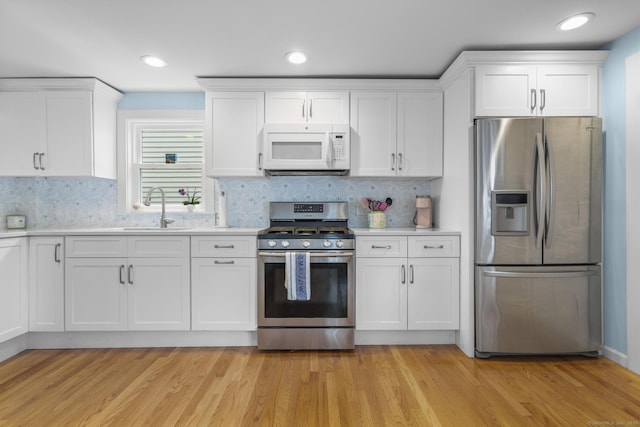 35 Lawrence Ave, Milford, CT 06460 - kitchen with appliances with stainless steel finishes, light countertops, white cabinetry, backsplash, and recessed lighting