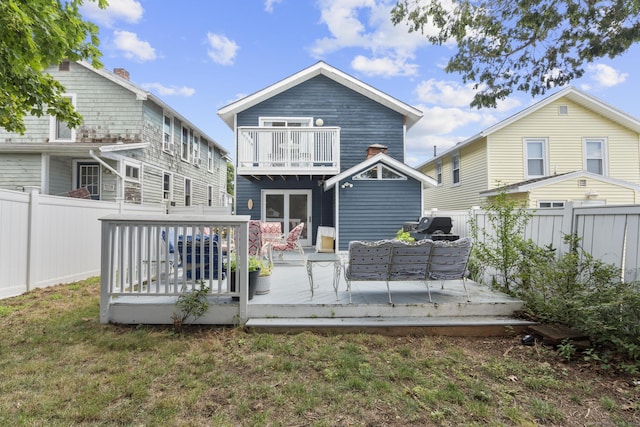 35 Lawrence Ave, Milford, CT 06460 - back of property with a fenced backyard, a balcony, and a deck