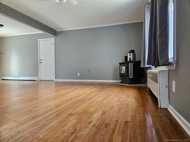 108 French St, Bristol, CT 06010 - unfurnished living room featuring radiator heating unit, wood finished floors, beamed ceiling, ceiling fan, and ornamental molding