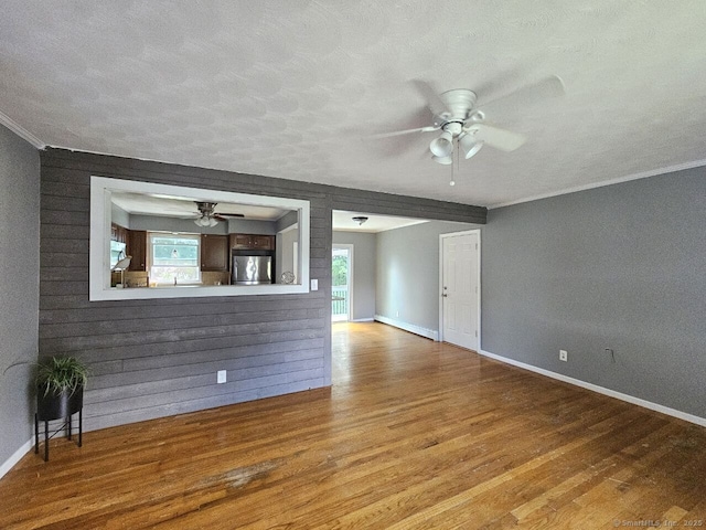 108 French St, Bristol, CT 06010 - unfurnished living room with a ceiling fan, wood finished floors, a textured ceiling, and crown molding