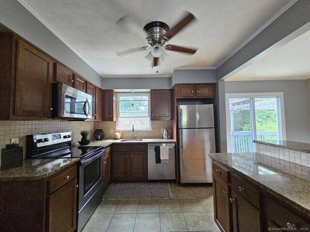 108 French St, Bristol, CT 06010 - kitchen featuring stainless steel appliances, decorative backsplash, ceiling fan, dark stone counters, and crown molding
