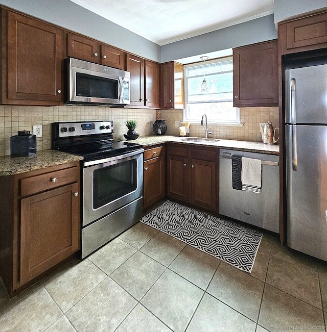 108 French St, Bristol, CT 06010 - kitchen featuring stainless steel appliances, crown molding, tasteful backsplash, and light tile patterned floors