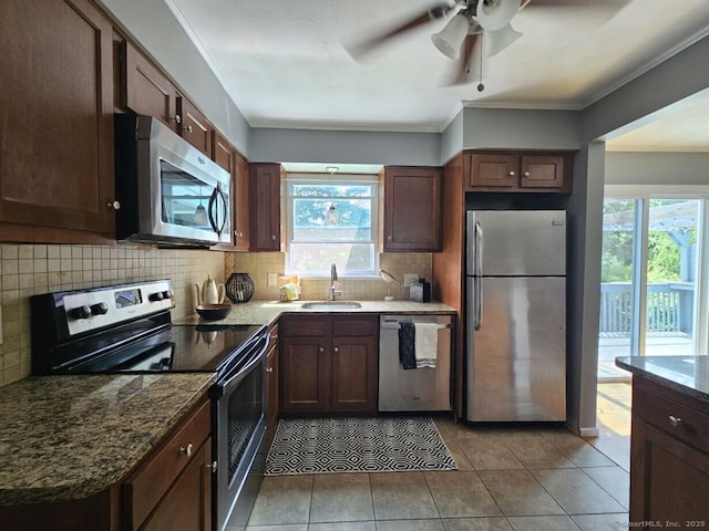 108 French St, Bristol, CT 06010 - kitchen featuring appliances with stainless steel finishes, healthy amount of natural light, backsplash, dark stone countertops, and crown molding