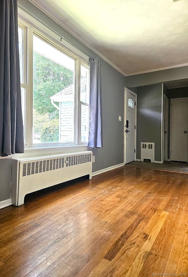 108 French St, Bristol, CT 06010 - entrance foyer featuring radiator, crown molding, and wood finished floors