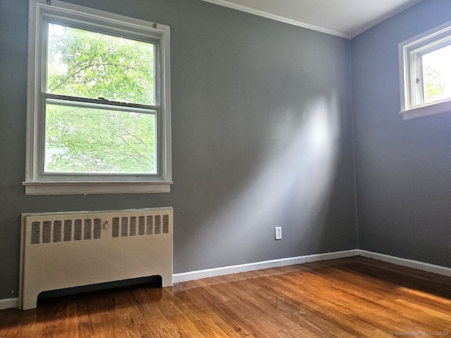 108 French St, Bristol, CT 06010 - unfurnished room featuring radiator heating unit, crown molding, and wood finished floors