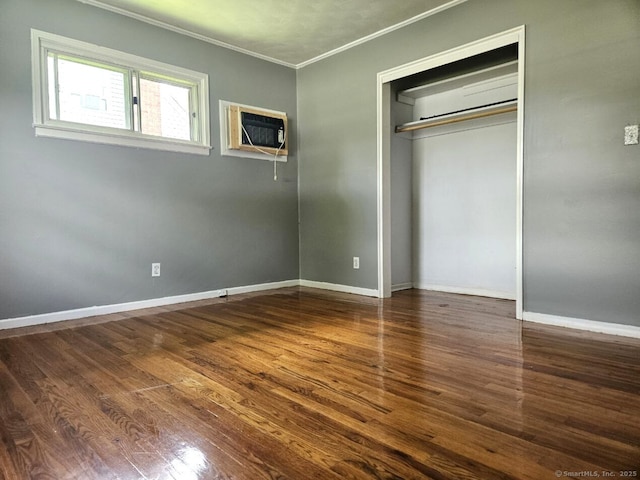 108 French St, Bristol, CT 06010 - unfurnished bedroom with crown molding, wood finished floors, a wall unit AC, and a closet