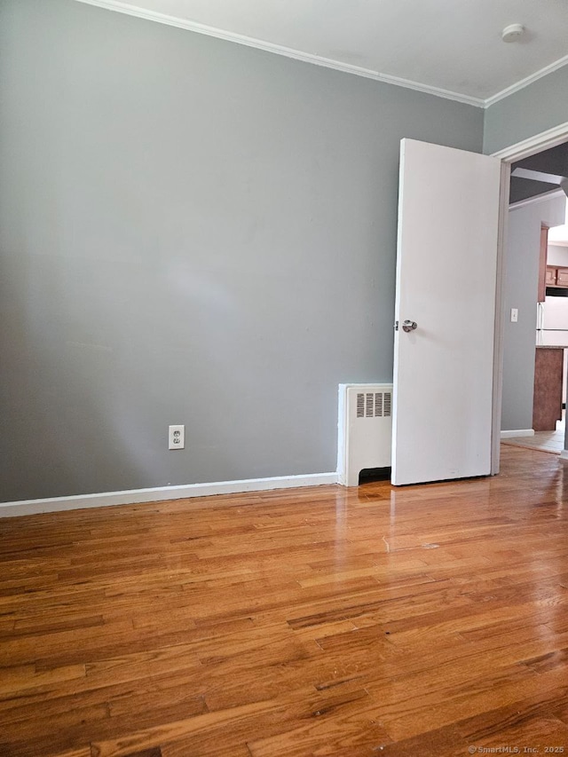 108 French St, Bristol, CT 06010 - empty room with radiator, crown molding, wood finished floors, and a smoke detector