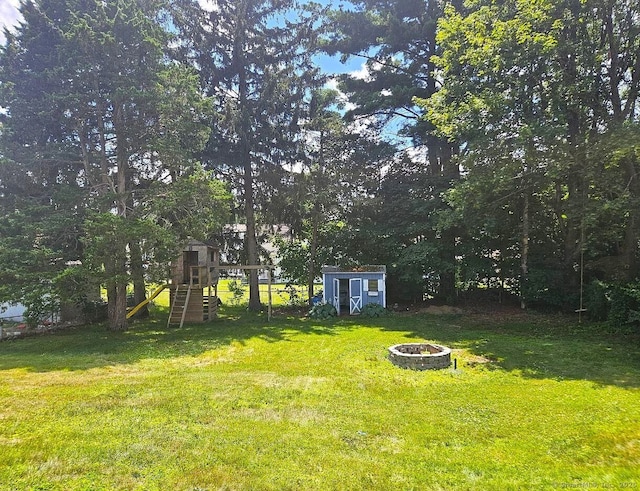 108 French St, Bristol, CT 06010 - view of grassy yard featuring an outdoor fire pit, a storage shed, and a playground