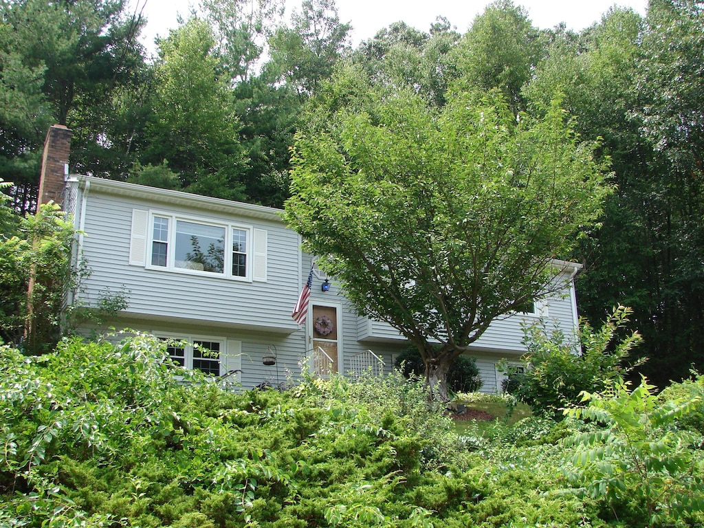 585 Perkins St, Bristol, CT 06010 - view of front of house featuring a chimney