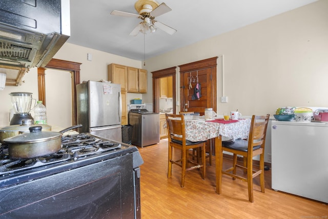 269 Olivia St, Derby, CT 06418 - kitchen with freestanding refrigerator, black gas range oven, washer / clothes dryer, ceiling fan, and light wood-style floors