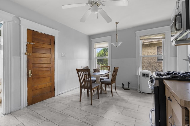 269 Olivia St, Derby, CT 06418 - dining area featuring a wainscoted wall and ceiling fan