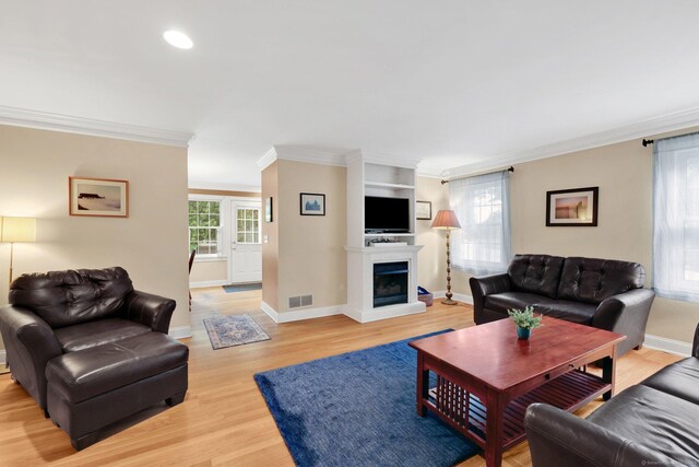668 Kings Hwy W Unit 668, Fairfield, CT 06890 - living area featuring light wood-style floors, crown molding, a fireplace with raised hearth, and recessed lighting