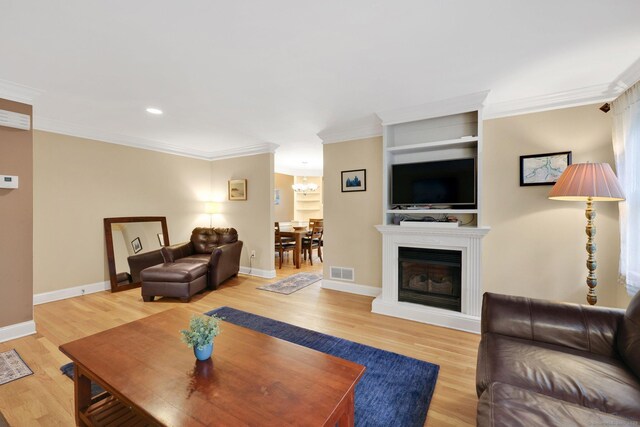 668 Kings Hwy W Unit 668, Fairfield, CT 06890 - living area featuring light wood-style floors, ornamental molding, a chandelier, a fireplace, and recessed lighting