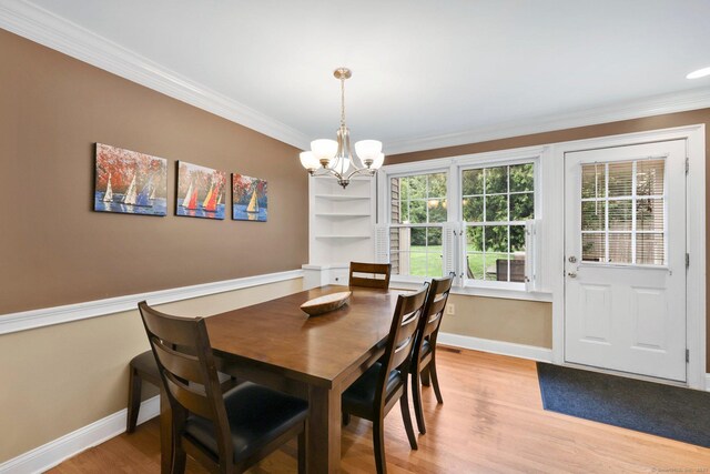 668 Kings Hwy W Unit 668, Fairfield, CT 06890 - dining space featuring ornamental molding, light wood finished floors, and a chandelier