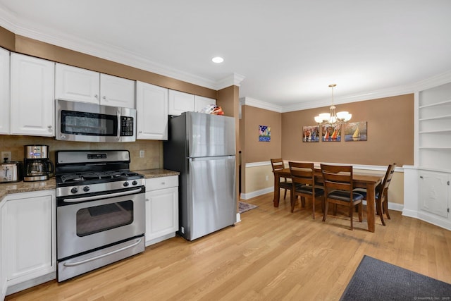 668 Kings Hwy W Unit 668, Fairfield, CT 06890 - kitchen with appliances with stainless steel finishes, a chandelier, light wood-type flooring, white cabinets, and crown molding