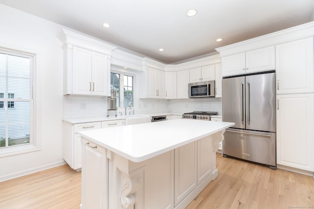 20 Stony Creek Rd Unit 20, Southington, CT 06479 - kitchen featuring appliances with stainless steel finishes, light wood-style flooring, tasteful backsplash, a kitchen island, and recessed lighting