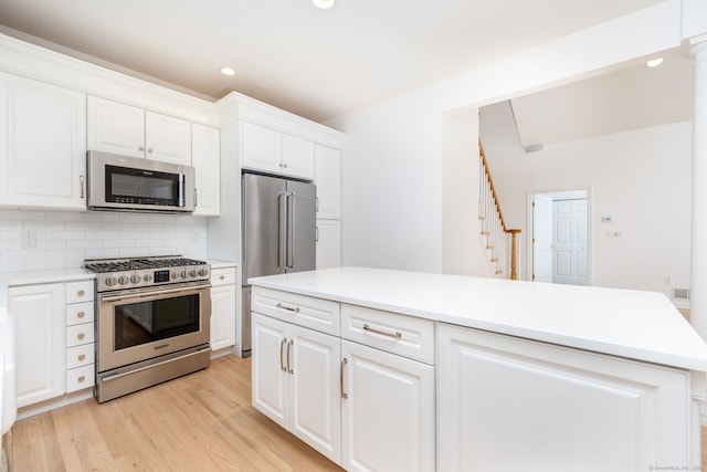 20 Stony Creek Rd Unit 20, Southington, CT 06479 - kitchen featuring appliances with stainless steel finishes, recessed lighting, light wood finished floors, backsplash, and white cabinetry