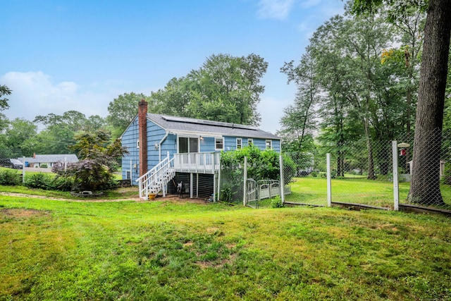 43 Kanter Dr, Vernon, CT 06066 - rear view of property featuring a chimney, solar panels, stairs, a lawn, and a deck