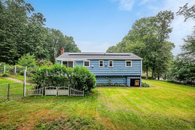 43 Kanter Dr, Vernon, CT 06066 - back of property featuring roof mounted solar panels and a chimney
