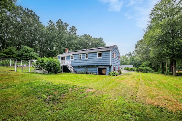 43 Kanter Dr, Vernon, CT 06066 - rear view of house featuring stairs, a chimney, and driveway