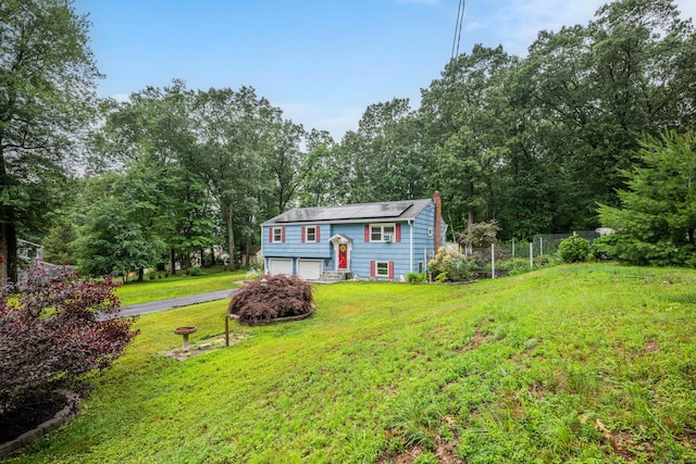 43 Kanter Dr, Vernon, CT 06066 - split foyer home with an attached garage, asphalt driveway, and a chimney