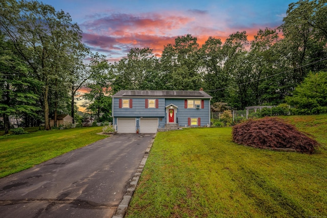 43 Kanter Dr, Vernon, CT 06066 - bi-level home featuring an attached garage, driveway, a front yard, and view of scattered trees