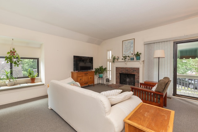 512 Heritage Vlg Unit B, Southbury, CT 06488 - living room featuring carpet floors, vaulted ceiling, and a brick fireplace