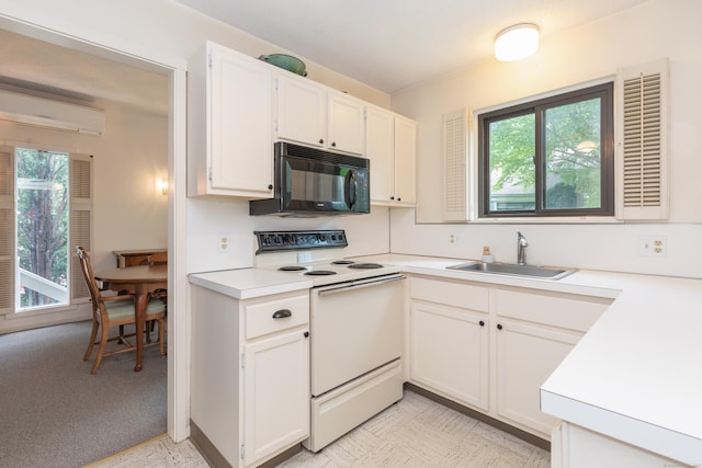 512 Heritage Vlg Unit B, Southbury, CT 06488 - kitchen featuring black microwave, white electric range oven, light countertops, an AC wall unit, and white cabinetry