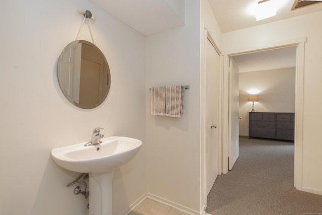 512 Heritage Vlg Unit B, Southbury, CT 06488 - bathroom featuring baseboards and a sink