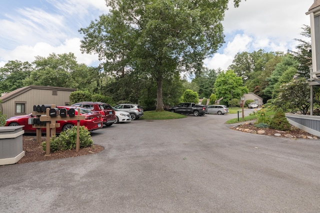 512 Heritage Vlg Unit B, Southbury, CT 06488 - view of asphalt driveway featuring view of wooded area