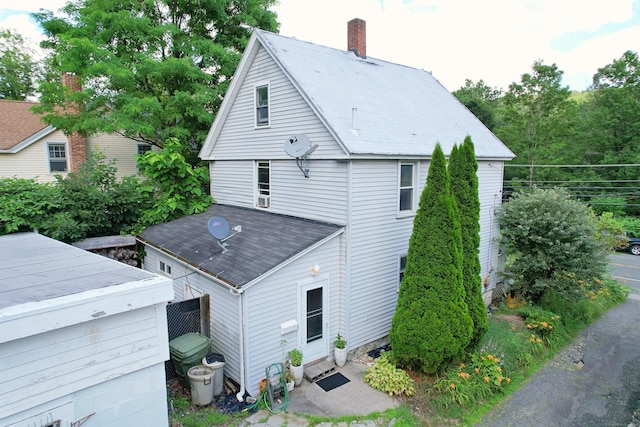 415 N Main St, Winchester, CT 06098 - rear view of house with a shingled roof and a chimney