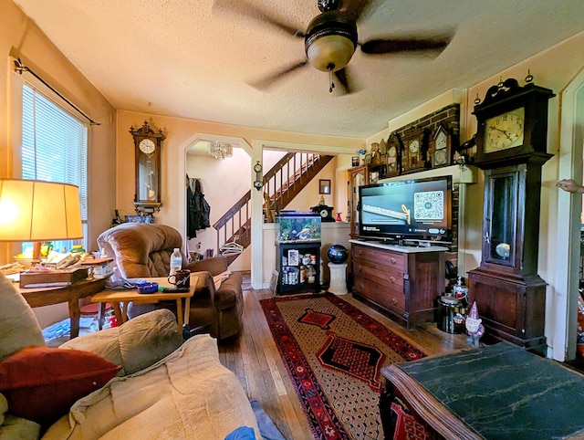 415 N Main St, Winchester, CT 06098 - living area featuring a textured ceiling, hardwood / wood-style floors, a ceiling fan, stairway, and arched walkways