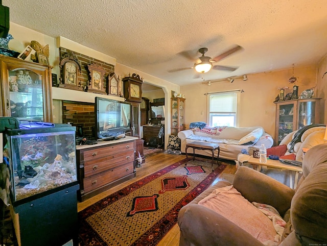 415 N Main St, Winchester, CT 06098 - living room featuring wood finished floors, a textured ceiling, ceiling fan, and arched walkways