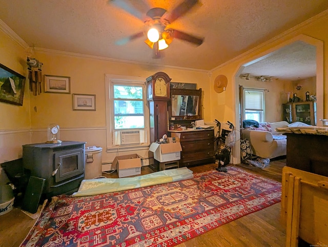 415 N Main St, Winchester, CT 06098 - living area with a textured ceiling, ornamental molding, wood finished floors, cooling unit, and a wood stove