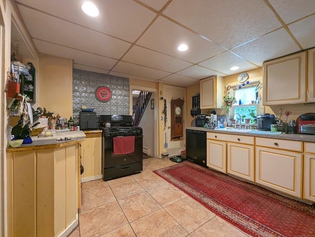 415 N Main St, Winchester, CT 06098 - kitchen featuring black appliances, a paneled ceiling, light tile patterned floors, and light countertops