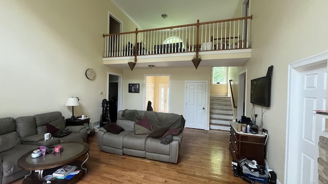 49 Ratlum Mountain Rd, Barkhamsted, CT 06063 - living room featuring a towering ceiling, stairway, and wood finished floors